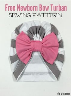 a pink bow on top of a white and gray striped hat with grey trims