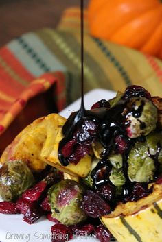 a white plate topped with brussel sprouts and cranberry sauce