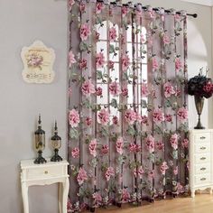 the curtains are decorated with pink flowers