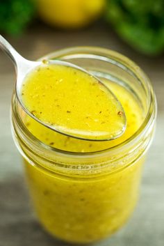 a jar filled with yellow liquid sitting on top of a table