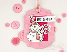 a pink tag with a snowman on it and buttons around it that say, my friend