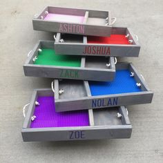 three trays that have different colored legos in them and the names on them