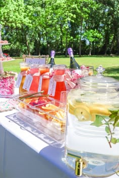 there are many drinks on the table and in glass jars with labels that say it's summer