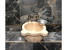 a marble sink in the corner of a bathroom