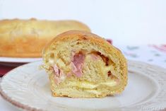 a ham and cheese roll on a plate