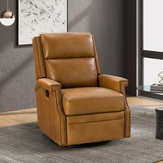 a brown recliner chair sitting on top of a rug in front of a window