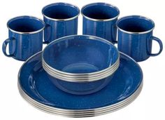 a blue dinner set with six cups and four saucers on the bottom one is empty