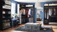 a bedroom with blue walls and lots of closet space