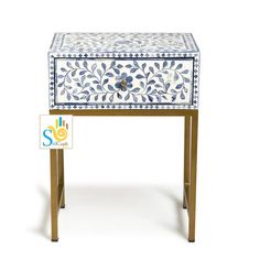 a white and blue table with drawers on it's sides, sitting against a white background