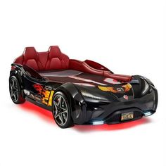 a toy car with flames on the side and red leather seats, in front of a white background