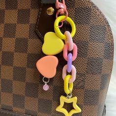 a brown bag with some colorful key chains attached to it