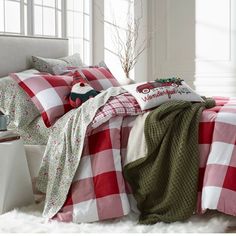 a red and white checkered comforter set on a bed