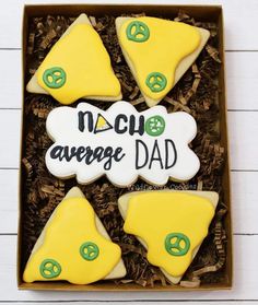 four decorated cookies in a box with the words'no chu average dad '