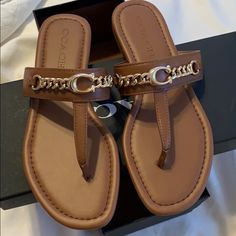 New Never Used Coach Open Toe Sandals For Vacation, Brown Flat Flip Flops, Coach Sandals For Vacation With Round Toe, Coach Sandals For Vacation, Chic Brown Toe Post Sandals, Trendy Coach Flat Sandals, Coach Leather Sandals For Vacation, Chic Coach Flat Heel Sandals, Coach Leather Sandals For Beach