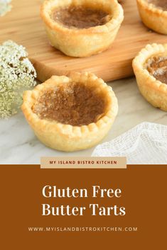 gluten free butter tarts on a cutting board with flowers in the background