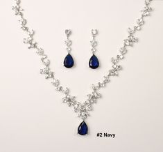 "The default will be: \"Navy Blue CZ Stone, Kraft/Tan box with twine  & no message\". If you need different colored Stone, please check the stone color chart in last photo &  specify the color number in checkout notes section. This three pieces jewelry set is made with high quality AAA cubic zirconia on triple white gold plated set.  The necklace has 15 CZ sections linked with a Teardrop CZ pendant size of 12 x16mm. Total length is 17-19 inches adjustable. Let me know if you would like customized to different length. Bracelet has 6 CZ sections linked to size of 6.5 inch. Extend clasp included to fit wrist size 6.5 ~7.5 inch. if you need custom length, please contact me for detail.  Drop Earring pendant size is 12x16mm, with total length 1.25 inch.  Earring has been triple plated to ensure Sapphire Bridal Jewelry, Dark Blue Jewelry Set, Navy Blue Jewelry Set, Royal Blue Prom Jewelry, Jewelry For Navy Blue Dress, Blue Silver Jewelry, Silver And Blue Necklace, Blue Prom Accessories, Blue Prom Jewelry