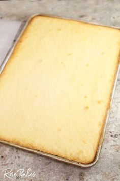 an uncooked square cake pan sitting on top of a marble counter next to a white paper towel