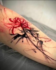 a woman's leg with red and black ink on it