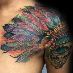 a man's chest with colorful feathers and a skull on it