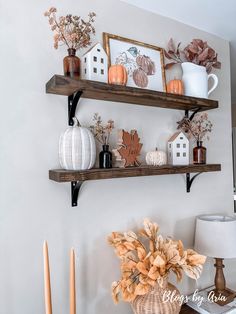 two wooden shelves with fall decorations on them