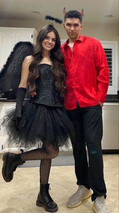 a man and woman dressed up in devil costumes