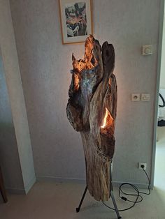 a lamp that is made out of wood and some kind of light on the floor