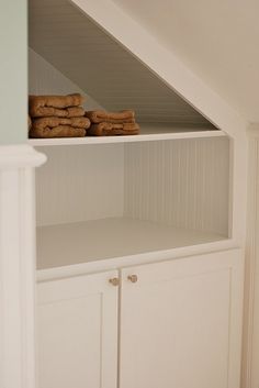 some cookies are stacked on top of each other in the corner of a white bookcase