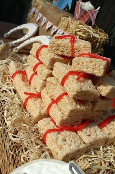 several pieces of food are stacked on top of each other with red ribbon around them