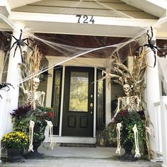 skeleton decorations on the front porch of a house