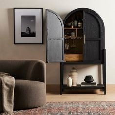 a living room with a couch, chair and cabinet