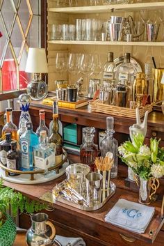 an assortment of liquor bottles and glasses on a table