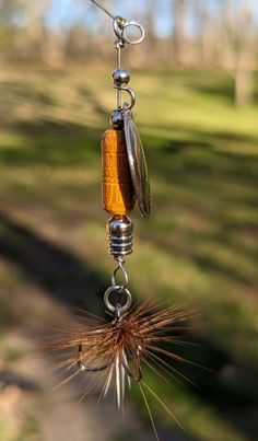 a close up of a wind chime hanging from a wire