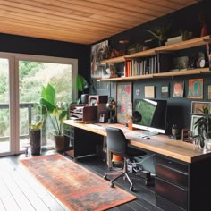 a home office with lots of plants on the desk