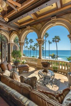 a living room filled with furniture and an ocean view