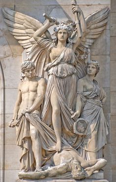 an image of a statue on the side of a building