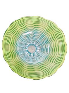 a green and blue bowl with wavy lines on it's surface, against a white background