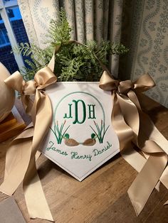 a potted plant sitting on top of a wooden table next to ribbon and decorations