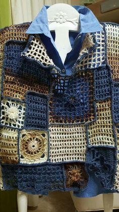 a crocheted blue and brown jacket on a mannequin