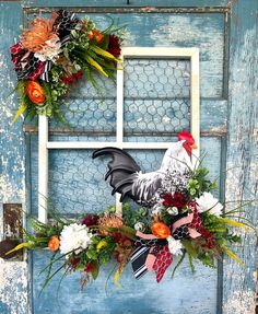 a rooster wreath on the side of a blue door