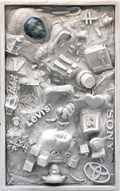 a metal plaque with various items on it and the words love is all around it