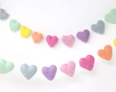 felt heart garland on white background with multicolored hearts