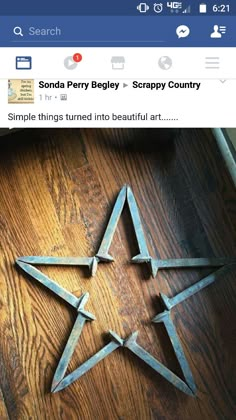 three metal stars sitting on top of a wooden floor