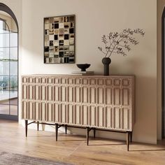 an art deco sideboard in the corner of a room with a vase on it