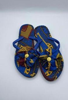 African Print/Ankara SlippersPamper your feet with a playful slipper featuring bow/rosette. Handmade from 100% African wax cotton, This stylish slipper is comfortable, stylish and durable guaranteed to last you for years. Definitely a "must-have" piece. It makes a great gift too! Comes in different colours and sizes, please check our other listings. p.s. Some comes as rosette and others as now will randomly be picked. Due to the pattern of fabric there may be slight variation. Blue Ankara, African Crafts, Printed Flip Flops, Ankara Print, Rope Necklace, Tory Burch Miller Sandal, Boys Clothing, Waxed Cotton, African Print