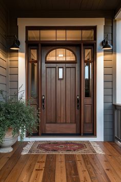 a wooden door with two planters on the side of it and a rug in front