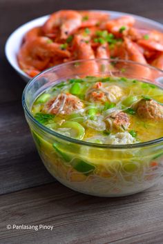 a bowl of soup with carrots, celery and meat