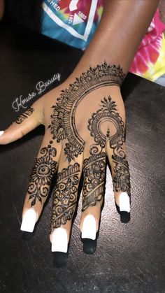 henna tattoo on the palm of someone's hand