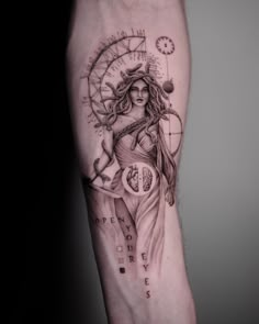 a woman's arm with a clock and compass tattoo on the left inner arm