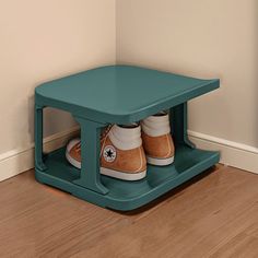 two pairs of tennis shoes are sitting on a shelf in the corner of a room