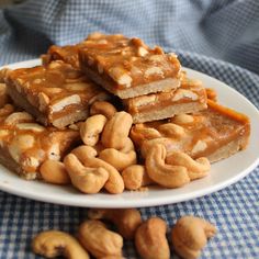 there are many pieces of food on the plate and one is peanut butter caramel bars